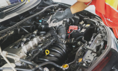 Auto mechanic working in garage. Repair service.