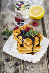 Belgian waffles with raspberries, blueberries and mint, covered