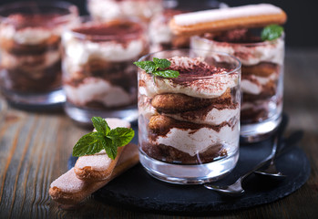 Italian dessert tiramisu in glass, sweet food - 130386560
