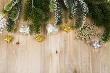 Silver snowflakes and fir branches on a wooden table. Christmas