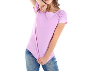 Fototapeta premium Young woman in blank color t-shirt on white background, close up