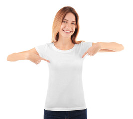 Fototapeta premium Young woman in blank t-shirt on white background