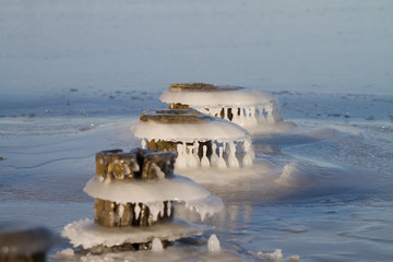 Frozen water on old waterbreaker poles