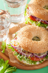 tomato sandwich on bagel with cream cheese onion lettuce alfalfa