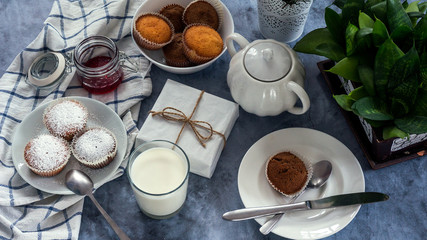 Bright and airy breakfast with muffin, berry jam and milk in glass. Top view
