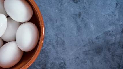top view of eggs in bowl with copy space for text