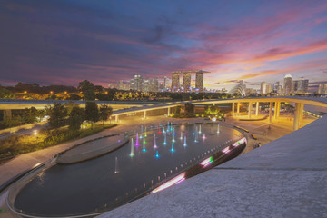 Fototapeta na wymiar Panorama of Singapore skyline illuminated in the evening twilight..