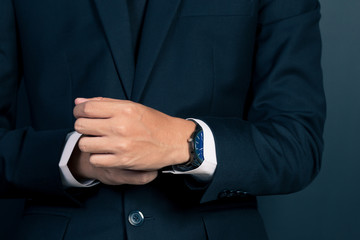 Obraz premium Businessman Fixing Cufflinks his Suit