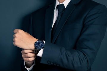 Businessman Fixing Cufflinks his Suit