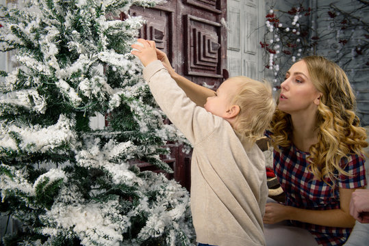 small child with my parents decorate the Christmas tree