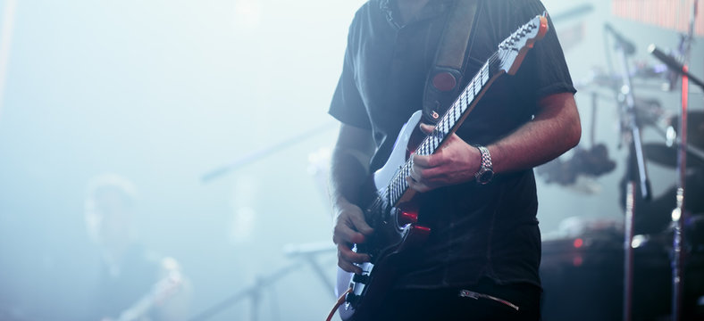 Guitarist performing on stage.
