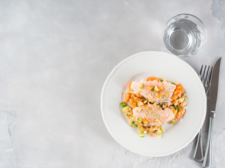 Salmon with vegetables on white plate. Lunch copy space
