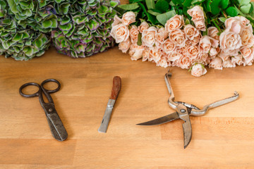 Florist work. Flower shop delivery, rose bouquet and tools