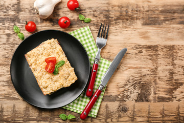 Homemade meat lasagna on wooden table, top view
