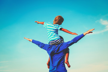 Fototapeta na wymiar happy father and son playing on sky