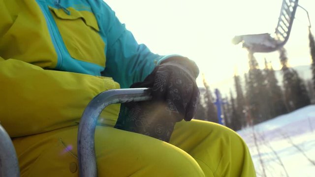 Skier in glasses skiing downhill in high mountains on ski lift during sunny day. 3840x2160