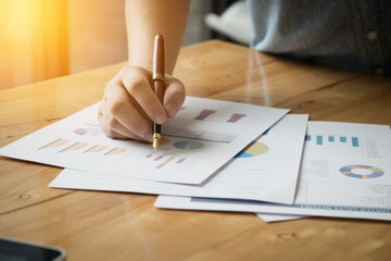 Close-up business woman working at the office. analysis document