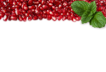 Background made of red pomegranate seeds. The scattered red grains of a pomegranate. Garnet at border of image with copy space for text. Top view.