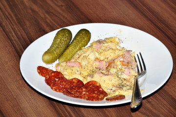 Eggs, ham, sausage and pickels breakfast