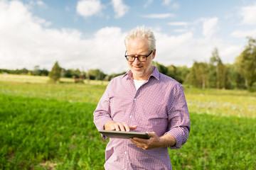 senior man with tablet pc computer at county