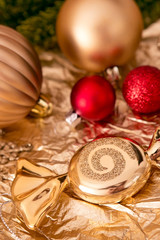 Gold and red Christmas balls, candy and branch of spruce on the