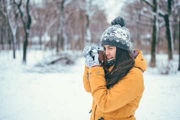 Stylish woman photographer with retro camera