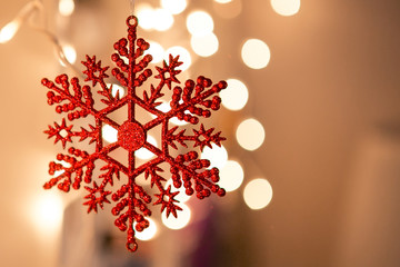 Red Christmas snowflake on a background of blurred lights - 130405751