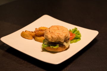 Cheese burger Served with french fries on wooden table