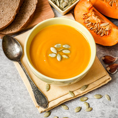 Pumpkin soup on gray stone background