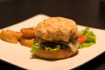 Cheese burger Served with french fries on wooden table