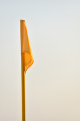 Detail shot with yellow corner flag on a soccer field
