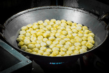 Chef cooking Fry the fish ball on a pan in kitchen stove., doing food