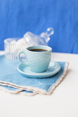 Blue on blue coffee cup and saucer with napkin marshmellou