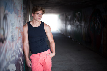 close up image of a good looking male model in a subway with gra