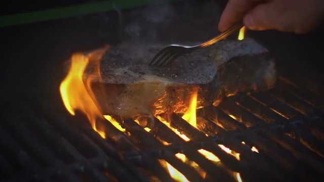 Rib Eye Steak on BBQ Grill slow motion footage