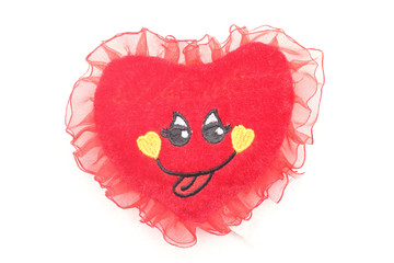 Soft toy in love heart with cute little face.