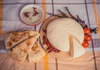 White cottage cheese with cherry tomatoes, red chili pepper and herbs. Farmer cheese on white...