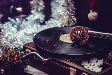 Image of Christmas. Gramophone playing a record. Gramophone with vinyl record on a background of...