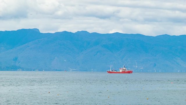 Chilean Commercial Fishing Boat near the South American City of Puerto Montt Chile with Majestic Blue Mountains Backdrop