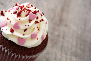 Valentine cupcakes decorated with sweet hearts on wooden table
