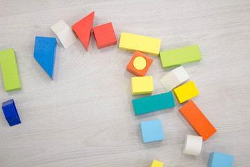 Scattered heap toy colored wooden bricks