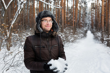 Man in fur winter hat with ear flaps smiling portrait