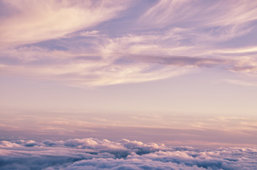 Abstract background with pink, purple and blue colors clouds. Sunset sky above the clouds. Dreamy...