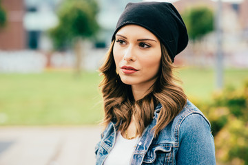 Portrait of young handsome caucasian blonde straight hair woman looking over serious, wearing white shirt and jeans jacket - thinking future, pensive concept