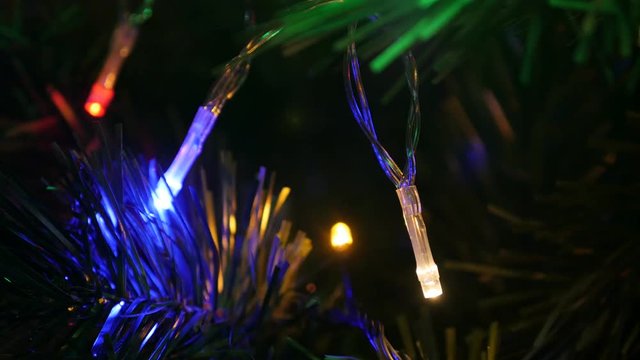 Decorative colorful bulbs on Christmas tree close-up 4K 2160p 30fps UltraHD footage - Dot lights blinking at night shallow DOF 3840X2160 UHD video 