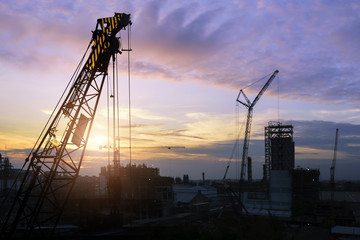 Construction site .Silhouette structural steel beam build large residential buildings at construction site .