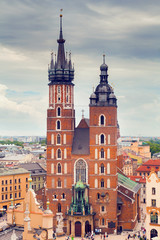 Fototapeta premium Church of St. Mary in the main Market Square on the background of dramatic sky. Basilica Mariacka. Krakow. Poland.