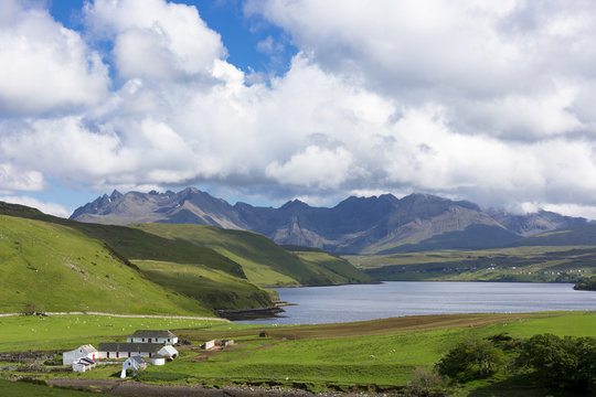 Clouds over the Cuillin mountain range with croft farm and Loch Harport near Coillure, Isle of Skye, Highlands and Islands, Scotland