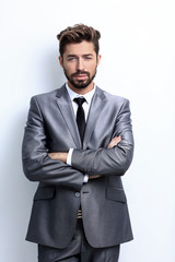 Close up portrait of a smiling handsome business man  over white