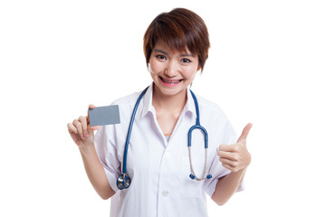 Asian young female doctor show thumbs up with blank card.